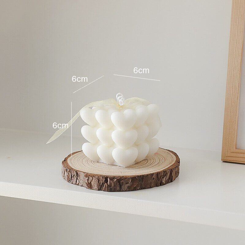 Heart-shaped candle on wood slice (2_496e42e3)