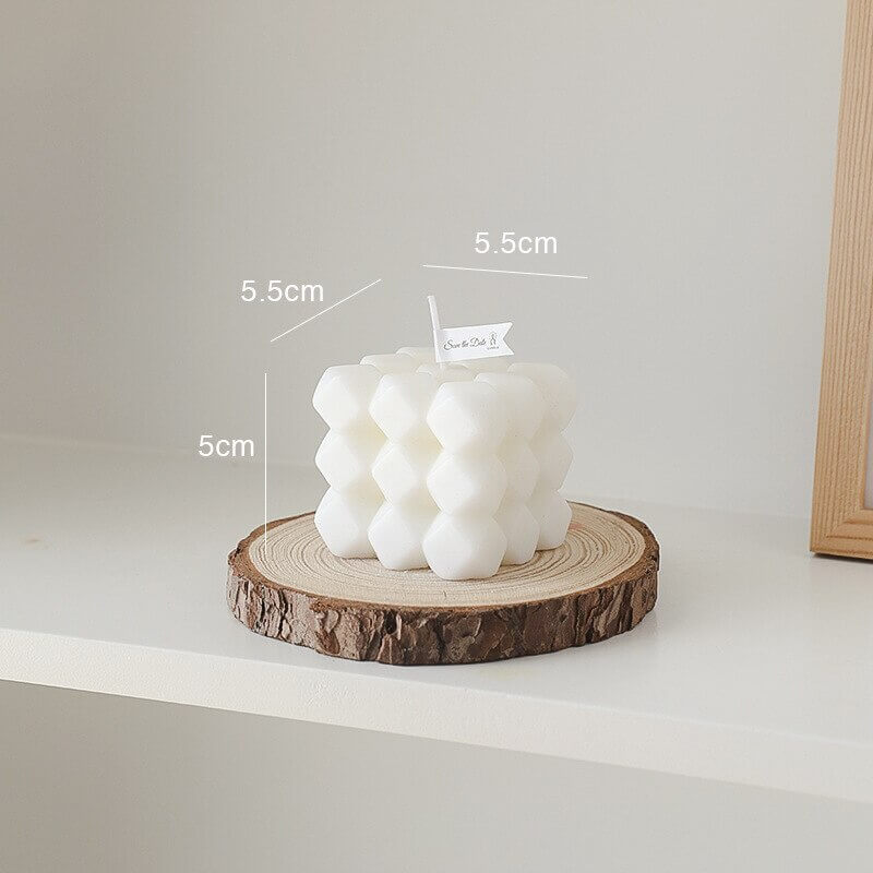 White bubble candle on wood slice (4_33a0d368)