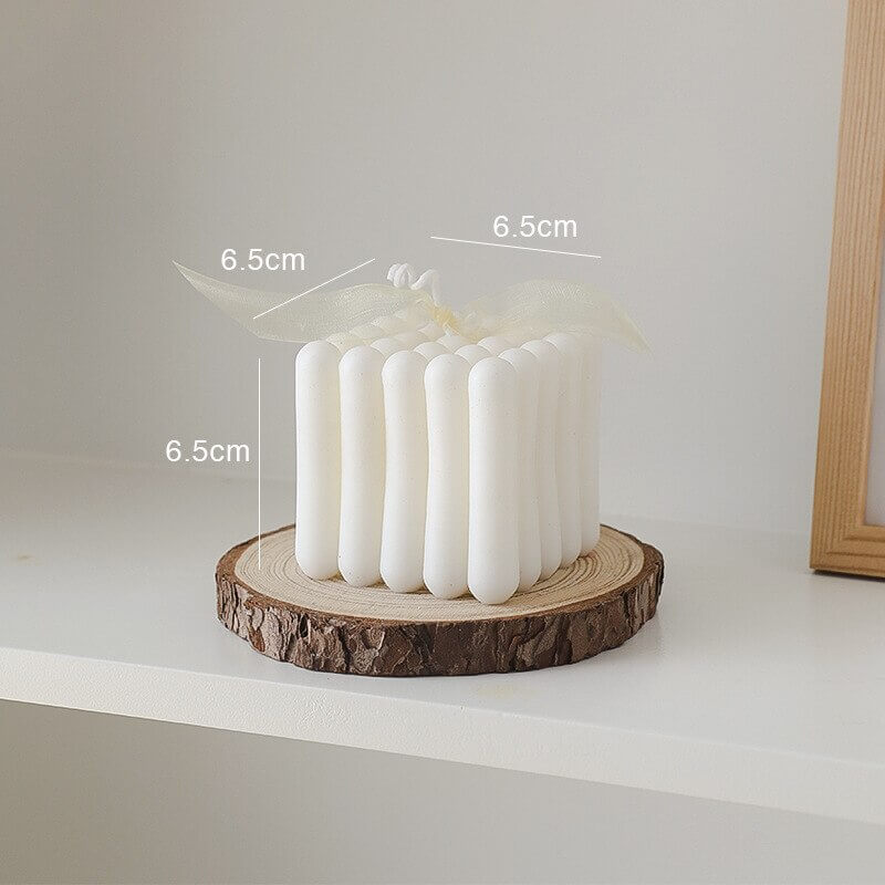 White pillar candle on wood slice (6_aa731e58)