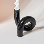 Black glass candlestick with spiral candle
