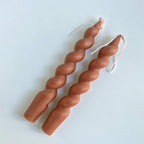 Two brown spiral scented candles