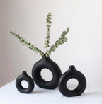 Black donut vases with eucalyptus